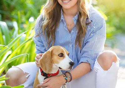portrait photo of a college senior girl with a puppy in Dubai