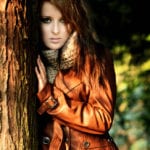 girl standing by a tree wearing a Karen Millen leather jacket