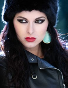 model posing in a Russian hat and leather jacket