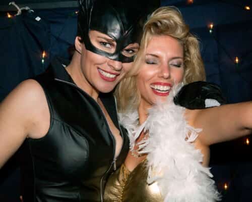 Catwoman and Marilyn Monroe at a fancy dress party